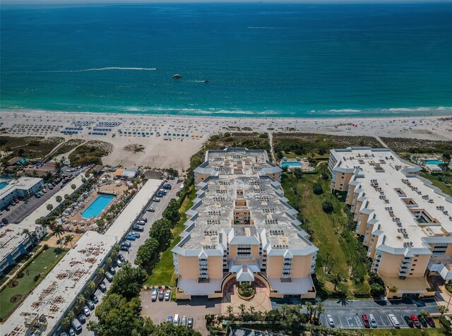 birds eye view of property with a water view and a view of the beach