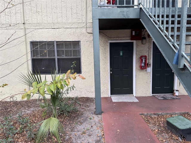 view of exterior entry featuring stucco siding