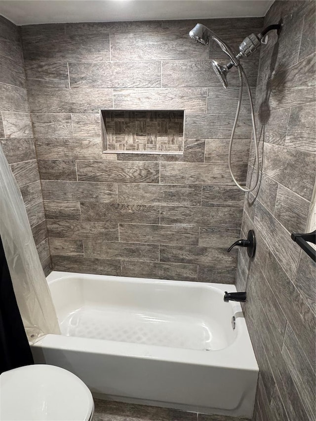 bathroom with toilet and shower / tub combo