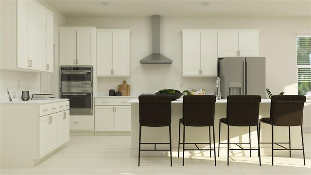 kitchen featuring double oven, white cabinetry, wall chimney exhaust hood, and white fridge with ice dispenser