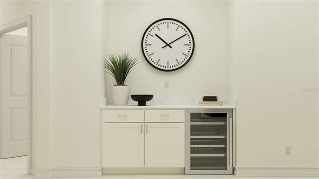bar featuring white cabinetry and beverage cooler