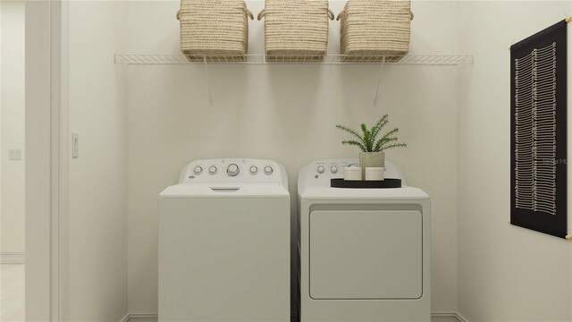 clothes washing area featuring washing machine and clothes dryer