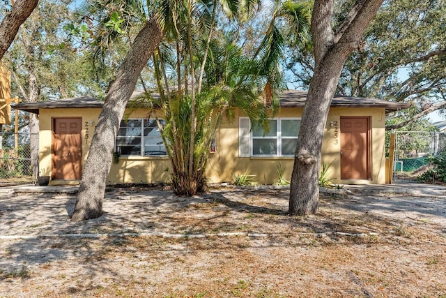 view of front of property featuring fence and stucco siding