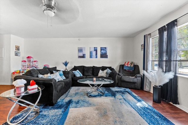 living room with ceiling fan, wood finished floors, and baseboards