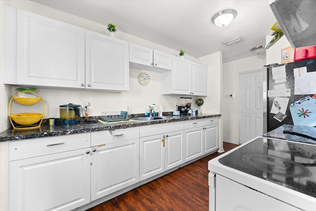 kitchen with a sink, white cabinetry, dark wood-type flooring, and electric stove