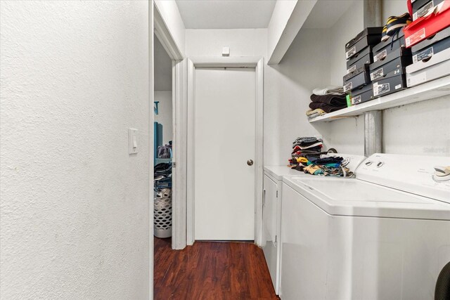 laundry room with dark wood-style floors, washing machine and dryer, laundry area, and a textured wall