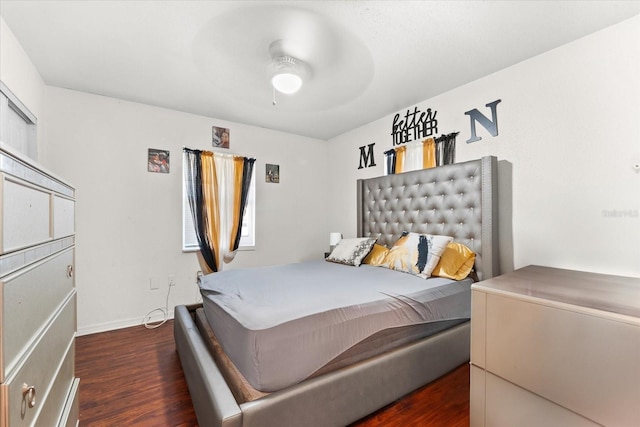 bedroom with ceiling fan, baseboards, and dark wood finished floors