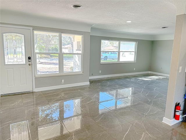 foyer with a textured ceiling