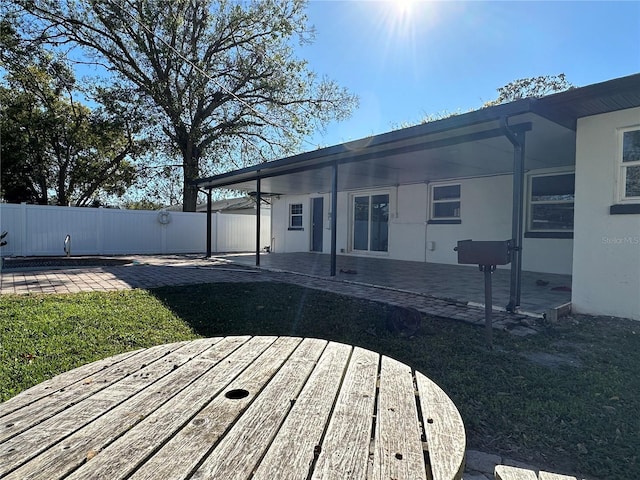 wooden deck featuring a patio area and a lawn