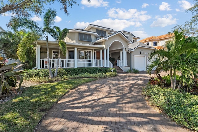 view of front of property with a porch and a garage