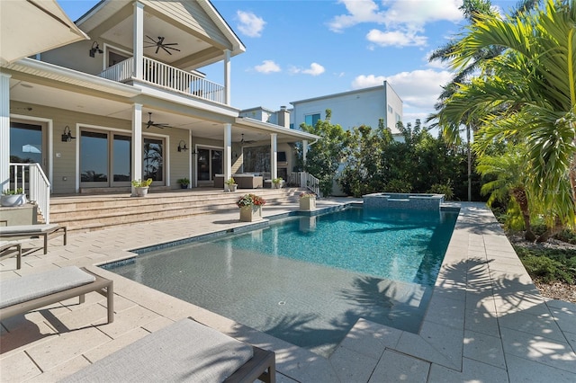 view of swimming pool with a patio, a pool with connected hot tub, and a ceiling fan
