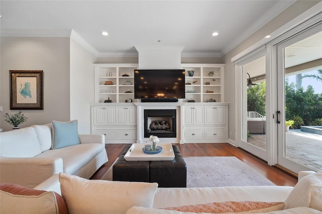 living room featuring a fireplace, ornamental molding, wood finished floors, and recessed lighting