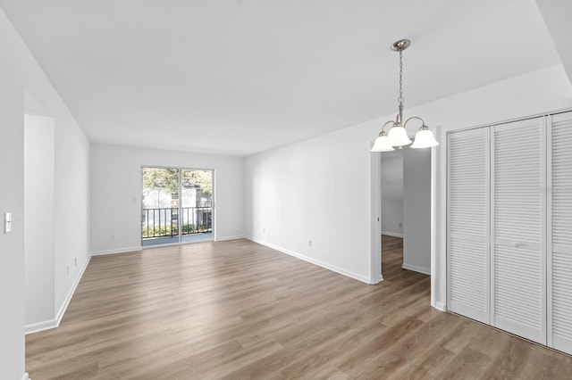 interior space with a chandelier and wood-type flooring