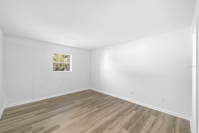 empty room with hardwood / wood-style flooring