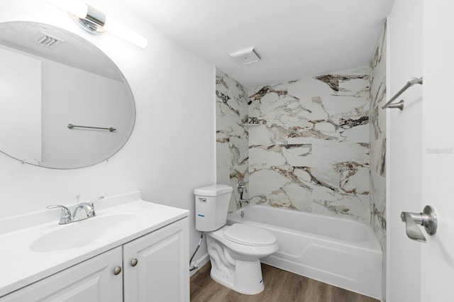 full bathroom featuring toilet, wood-type flooring, vanity, and tiled shower / bath