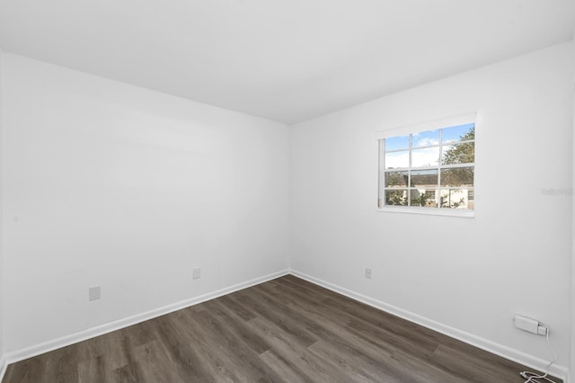 spare room with dark hardwood / wood-style floors