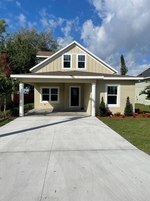 view of front of home featuring board and batten siding and a front yard