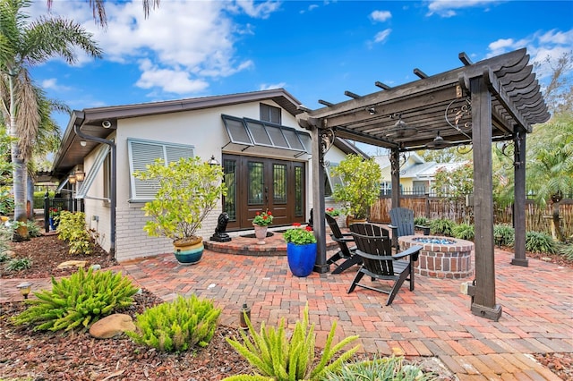 view of patio / terrace featuring french doors, a pergola, and a fire pit