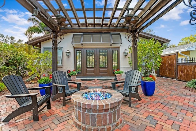 view of patio / terrace featuring an outdoor fire pit, french doors, and a pergola