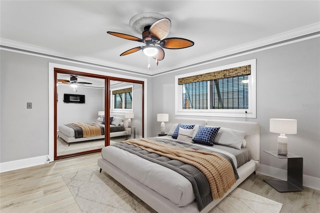 bedroom with light hardwood / wood-style floors, a closet, and ornamental molding