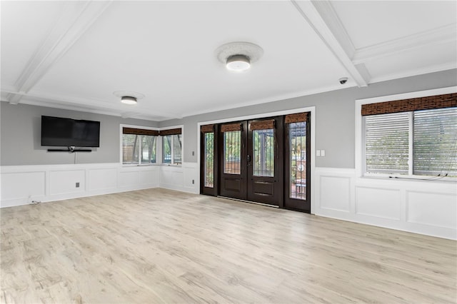 foyer entrance with light hardwood / wood-style flooring, a wealth of natural light, and beam ceiling