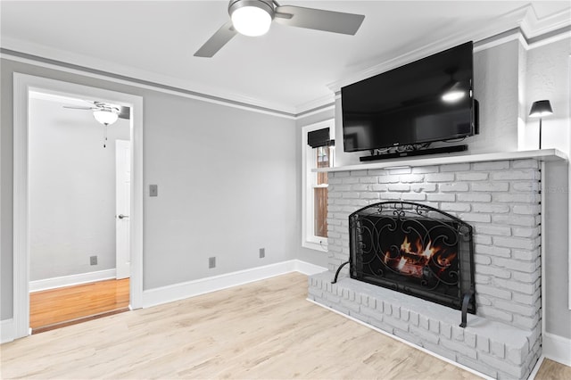 living room featuring light wood-type flooring, ornamental molding, a brick fireplace, and ceiling fan