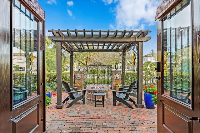 view of patio / terrace with a pergola and a fire pit