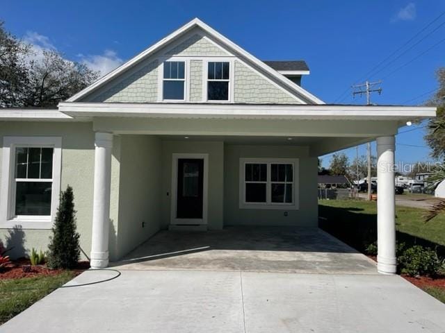 view of front of house featuring driveway and stucco siding