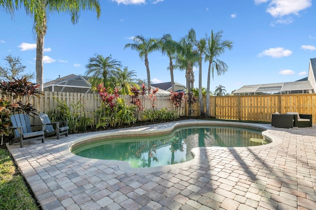 view of pool with a fenced in pool, a fenced backyard, and a patio