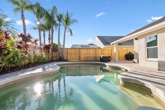 view of pool featuring area for grilling, a patio area, a fenced backyard, and a fenced in pool