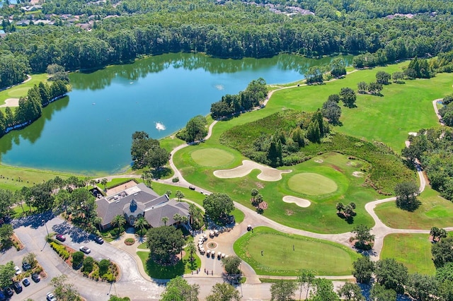 birds eye view of property with a water view, golf course view, and a view of trees