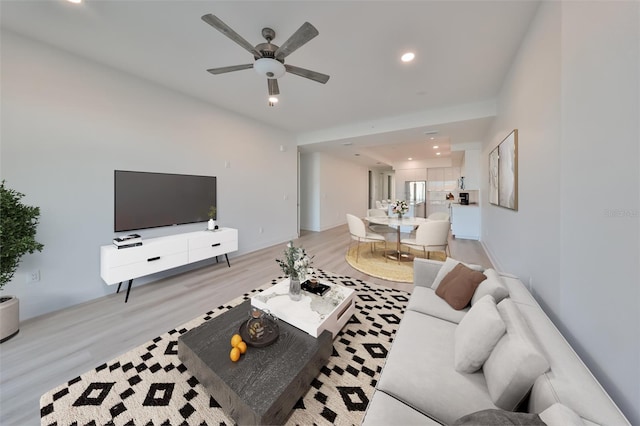 living room featuring light wood-type flooring and ceiling fan