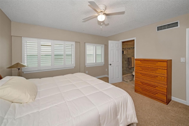 carpeted bedroom with ceiling fan and a textured ceiling