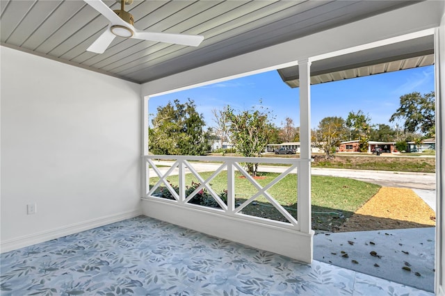 unfurnished sunroom with ceiling fan and wood ceiling