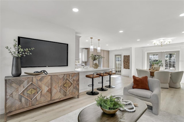 living room with light hardwood / wood-style floors and french doors