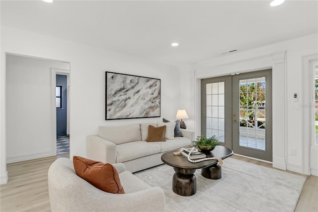 living room featuring light wood-type flooring and french doors