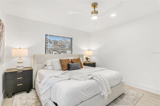 bedroom with light wood-type flooring and ceiling fan