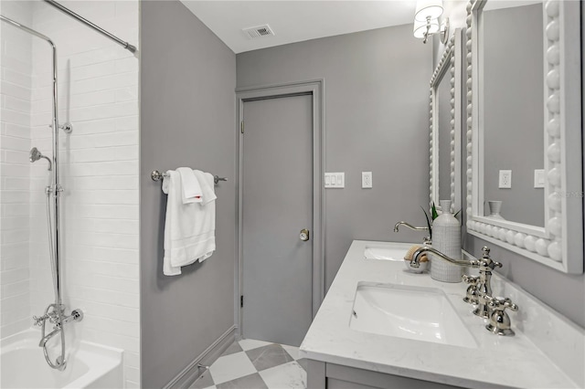 bathroom featuring vanity and tiled shower / bath