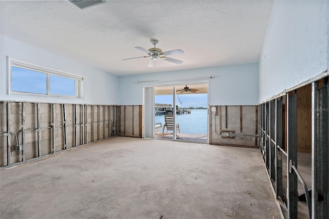 empty room with a water view and concrete floors