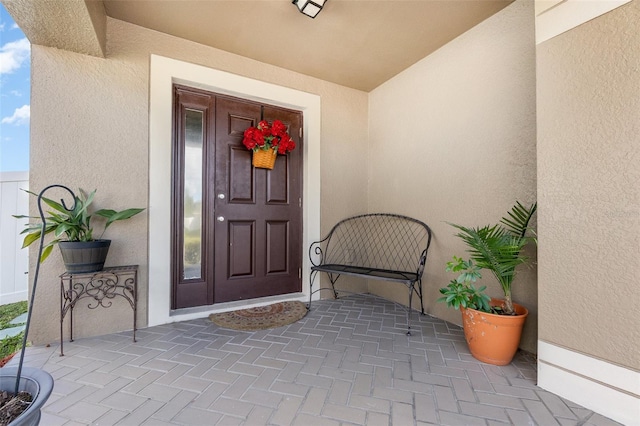 entrance to property with stucco siding