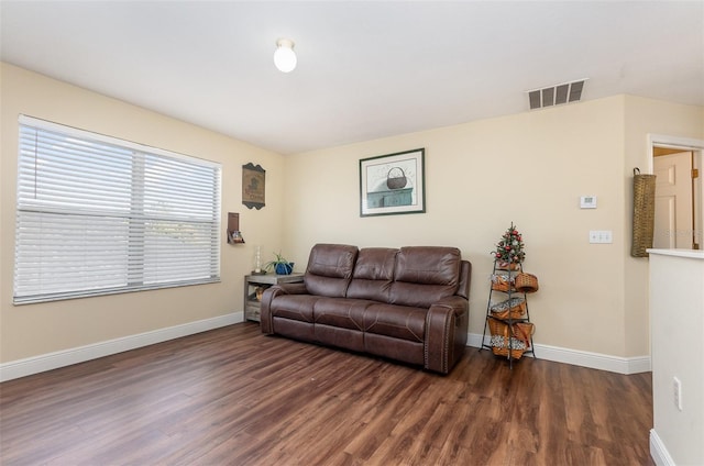 living room with visible vents, dark wood finished floors, and baseboards