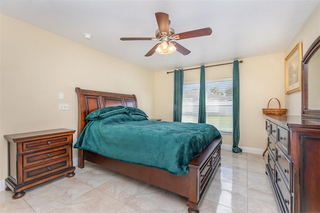 bedroom with ceiling fan and baseboards