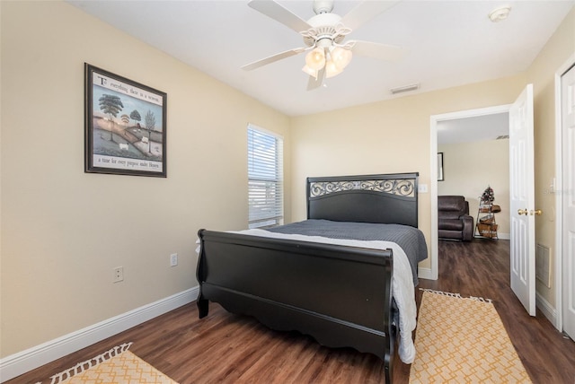 bedroom featuring a ceiling fan, visible vents, dark wood finished floors, and baseboards