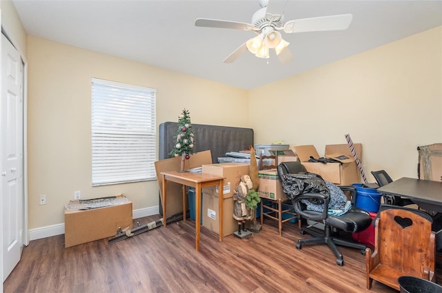 home office with ceiling fan, wood finished floors, and baseboards