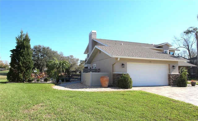 view of home's exterior featuring decorative driveway, a lawn, fence, and stucco siding