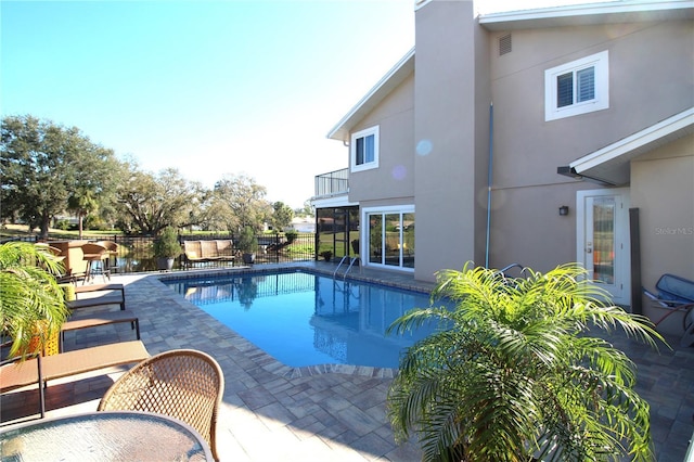 view of swimming pool with a patio, fence, and a fenced in pool