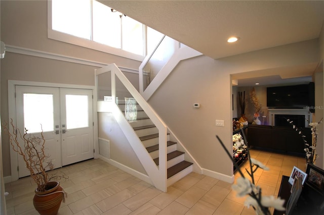 staircase featuring baseboards, french doors, visible vents, and recessed lighting