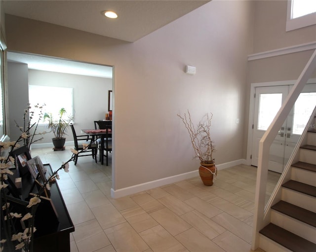 entryway featuring stairs, recessed lighting, and baseboards