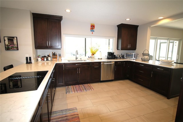 kitchen with a sink, a peninsula, stainless steel dishwasher, and black electric cooktop