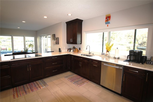 kitchen featuring plenty of natural light, light countertops, dishwasher, and a sink